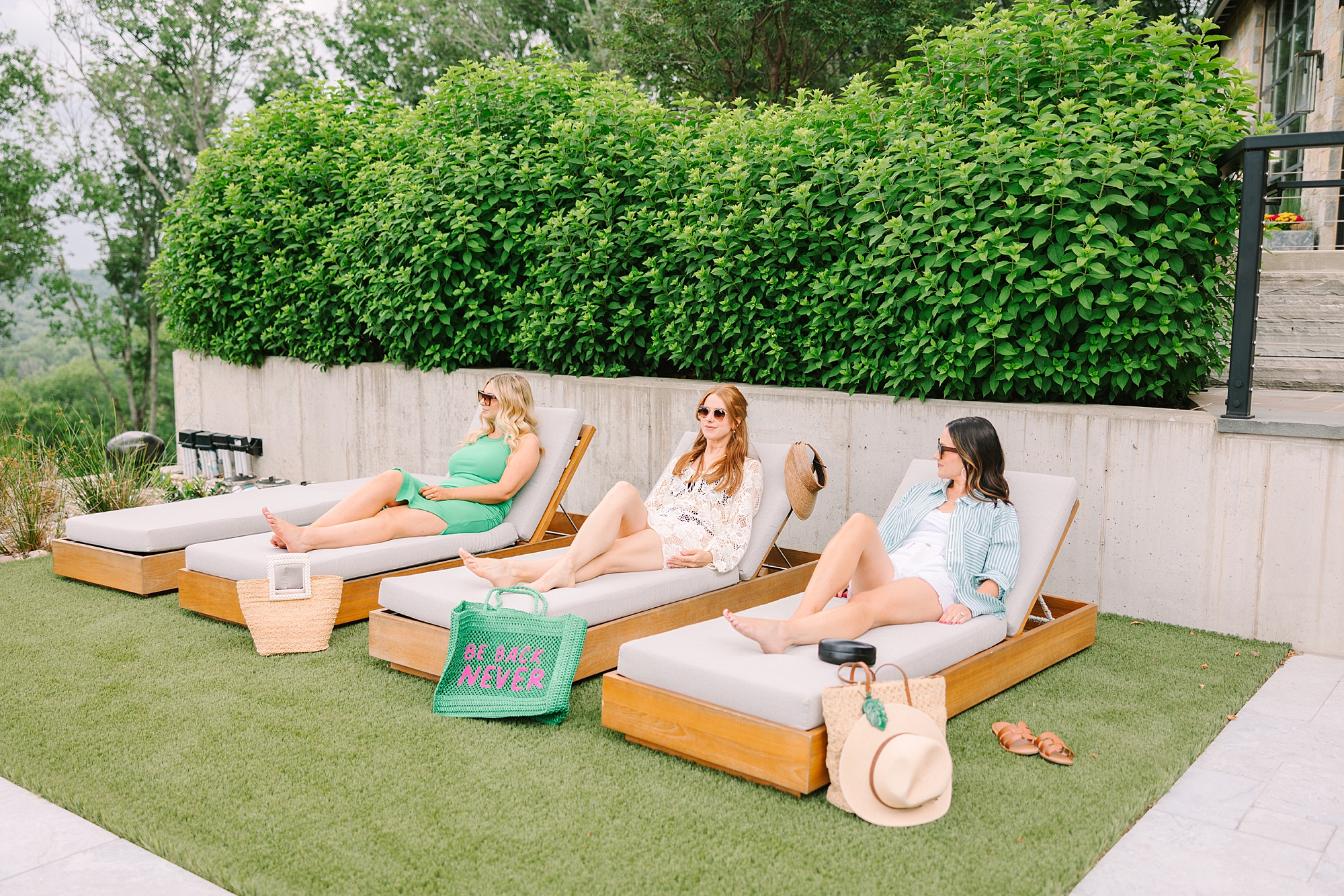 team reclines one loungers by pool talking during Nolensville TN branding session