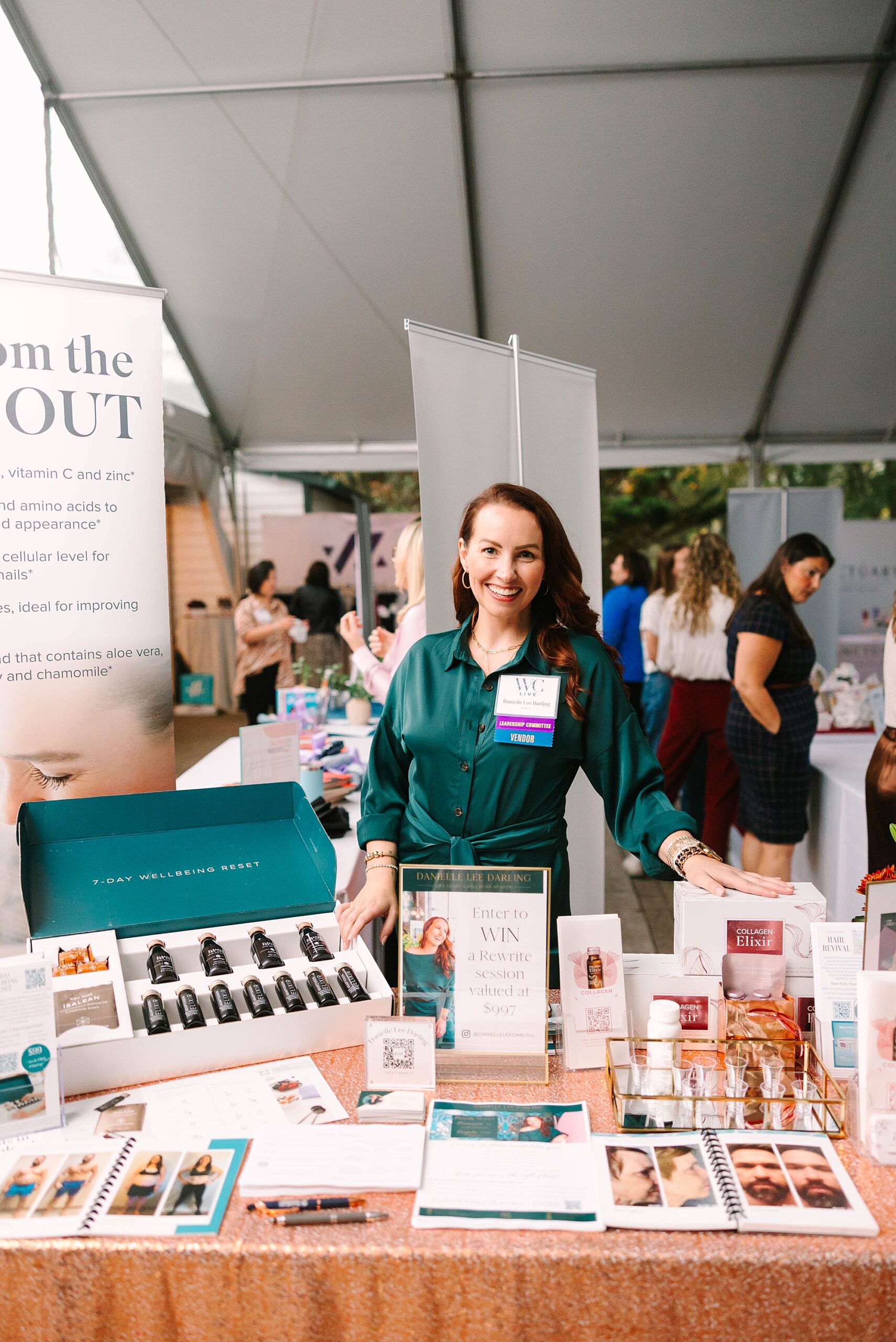 female business owner stands behind display table at Tennessee Women Connect Live Event