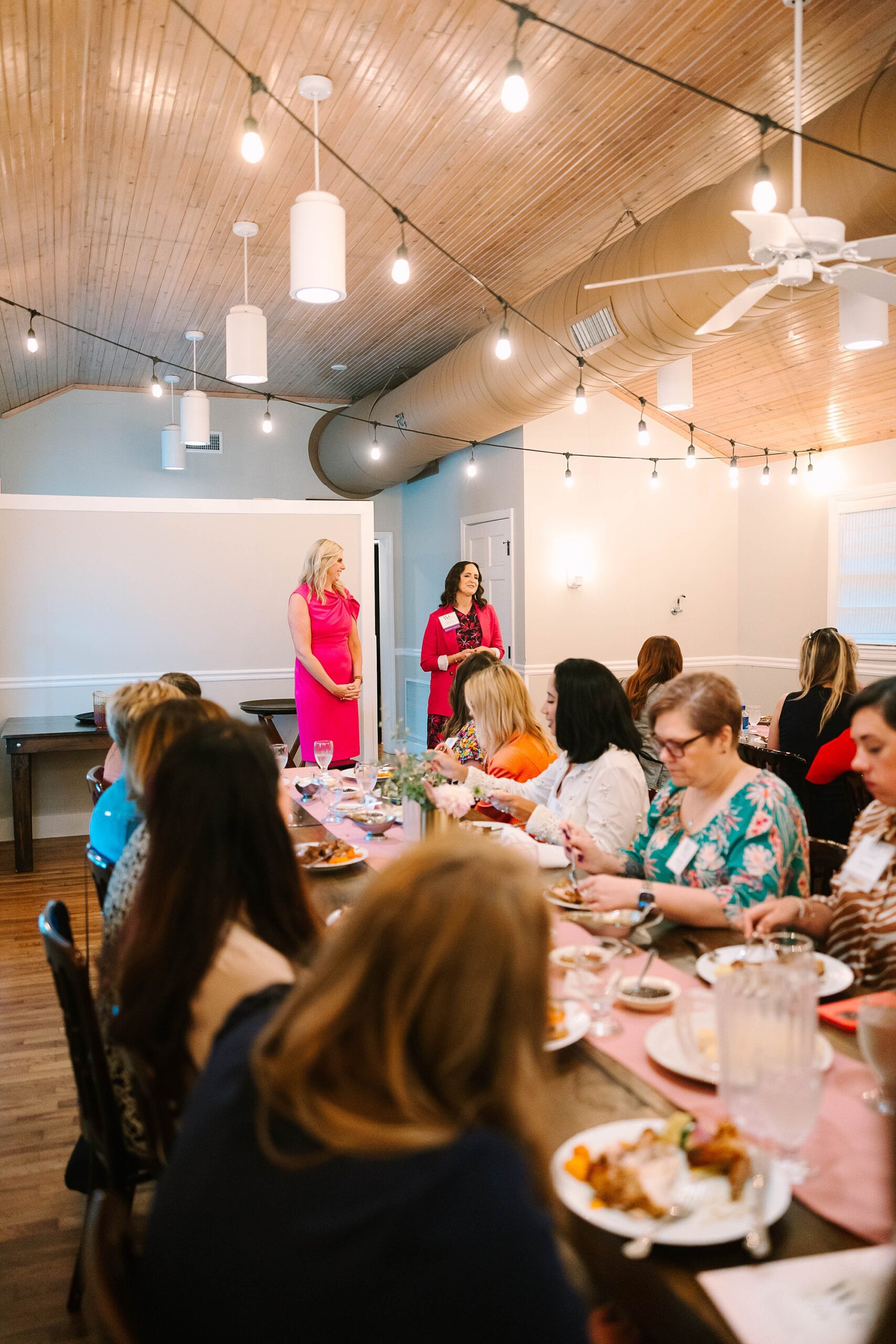 women speakers in pink outfits talk at Tennessee Women Connect Live Event