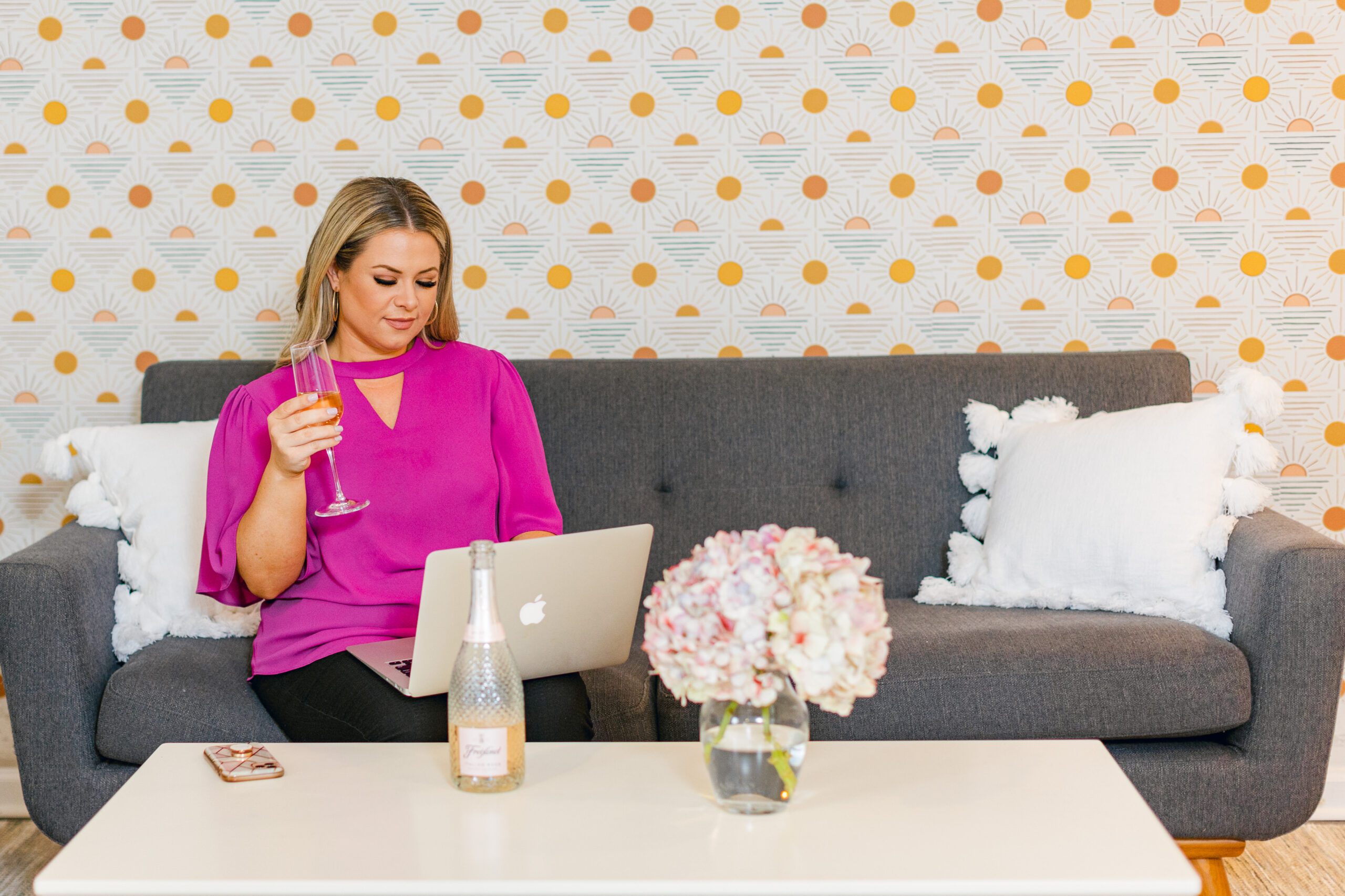 woman works on laptop on grey couch during Nashville TN Branding photos