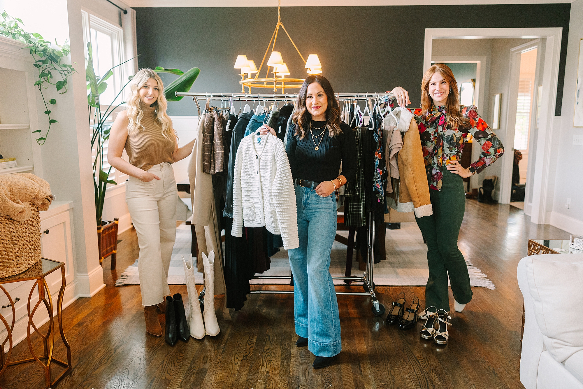 three stylists pose in front of rack of clothing during quarterly Nashville branding session for Be Styled Co.