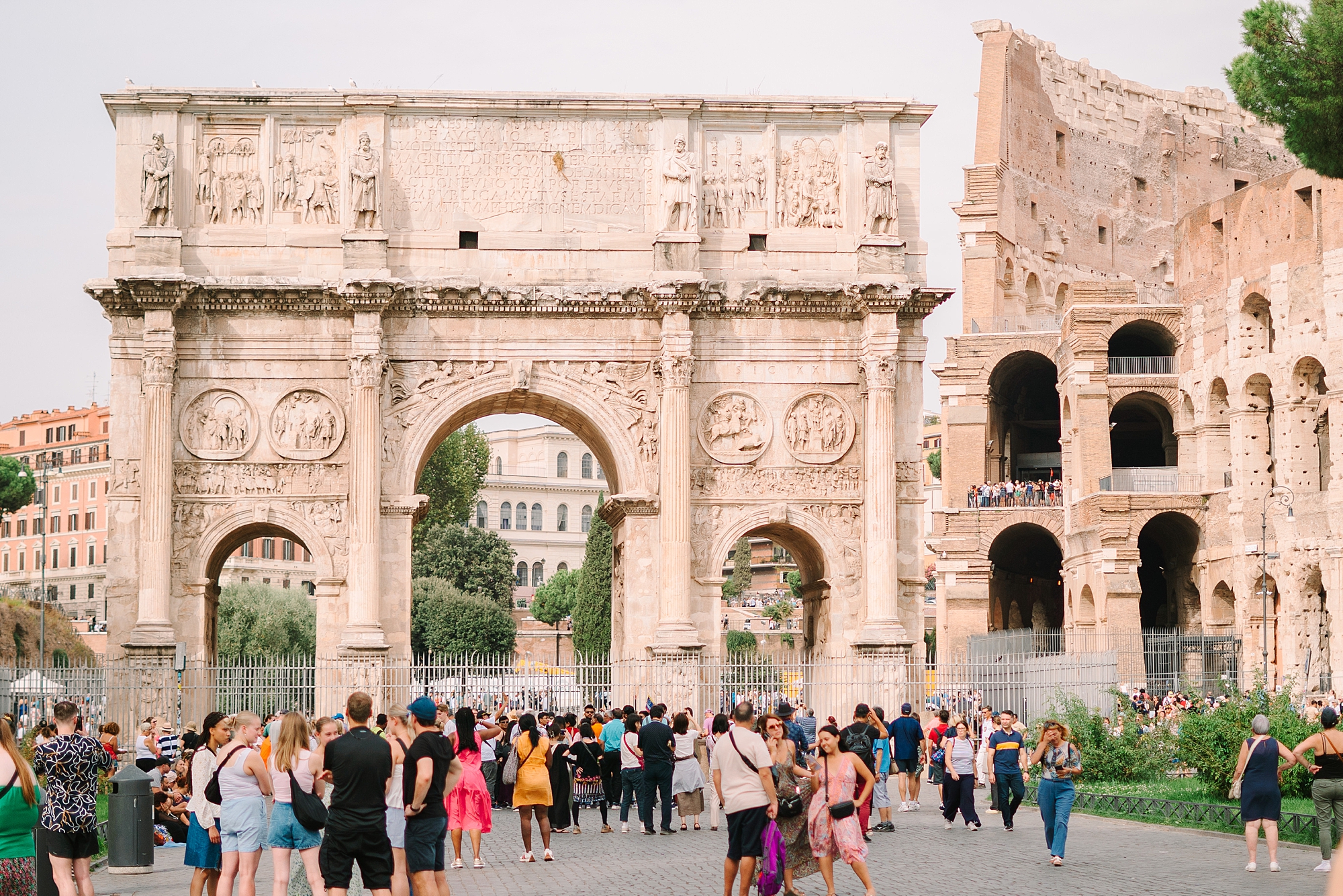 tourists mingle around the coliseum in Rome