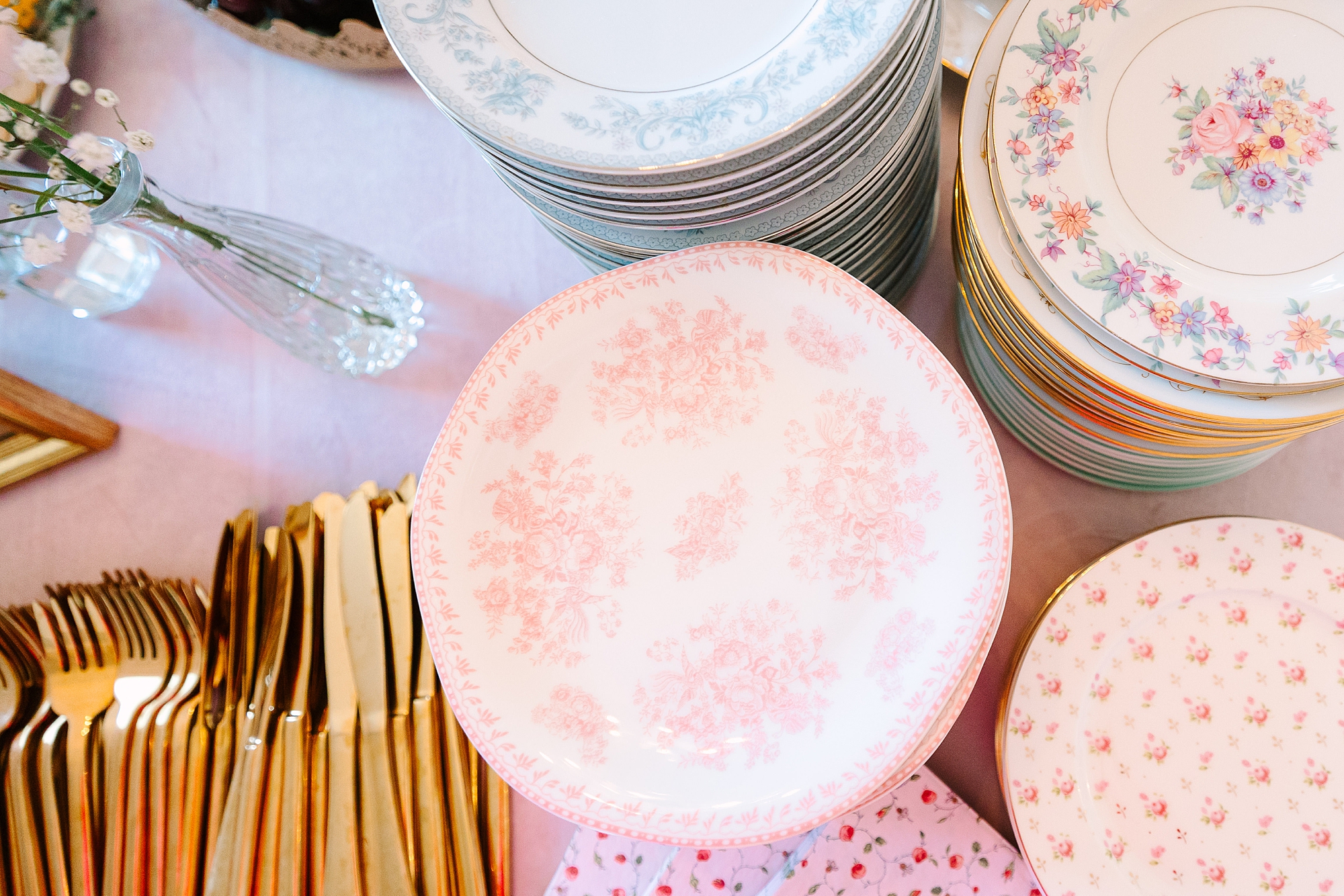 pink and white plates with gold silverware for holiday tea with Pretty Lovely Teas
