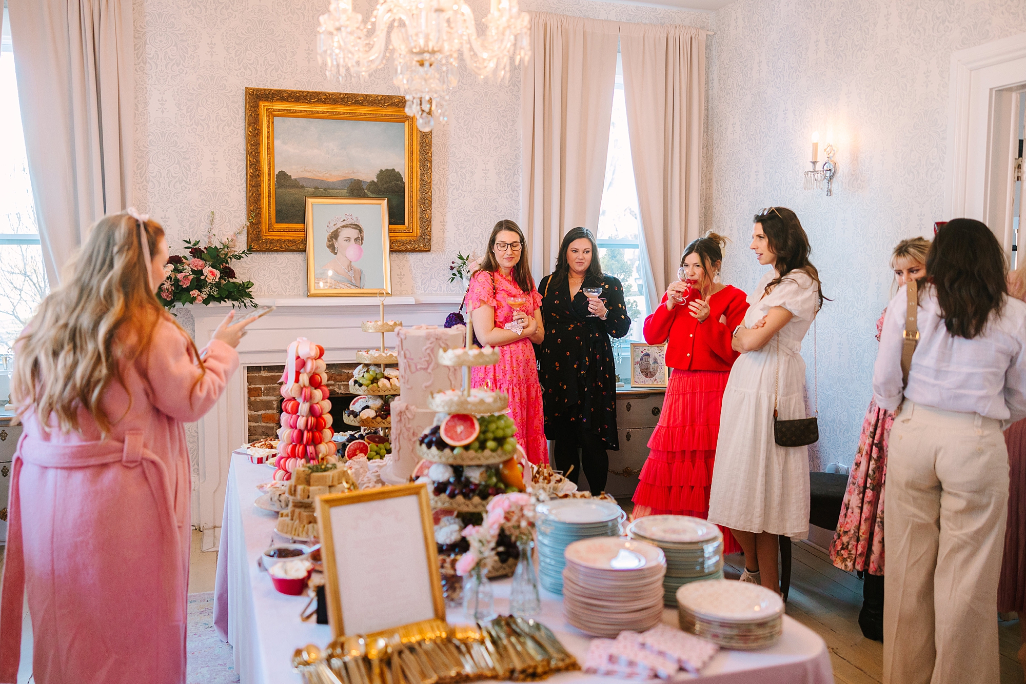 women mingle by fireplace during Galentine's Day Tea hosted by Pretty Lovely Teas