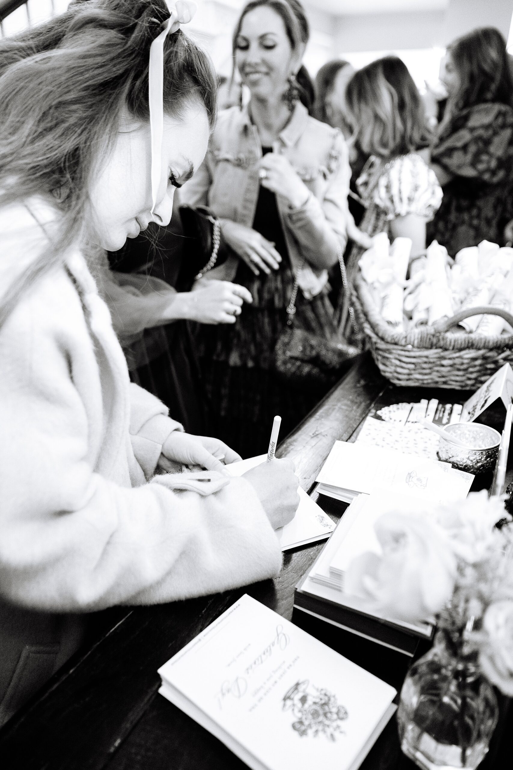 woman writes note during Galentine's Day Tea hosted by Pretty Lovely Teas