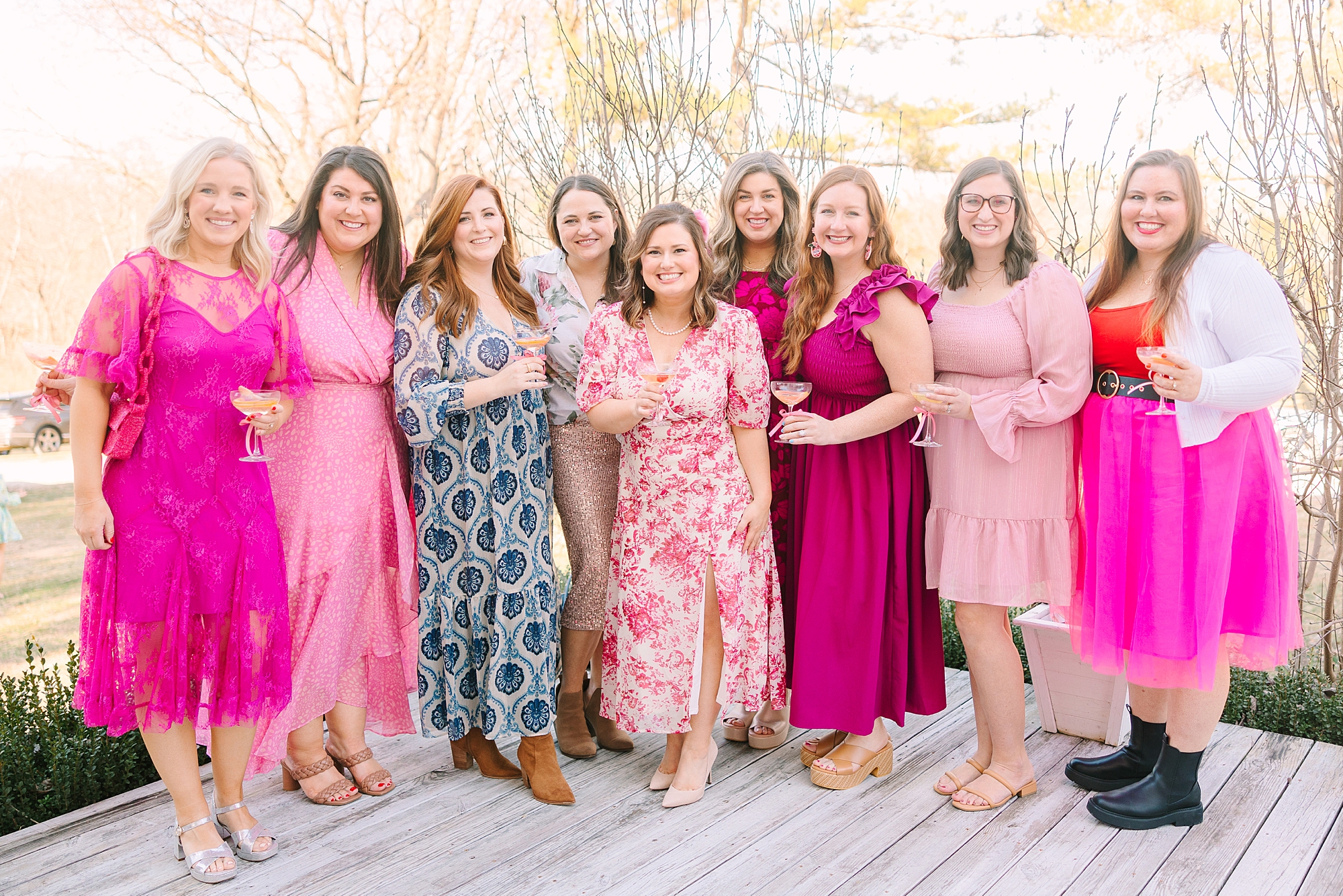 women pose in pink dresses during Galentine's Day Tea hosted by Pretty Lovely Teas