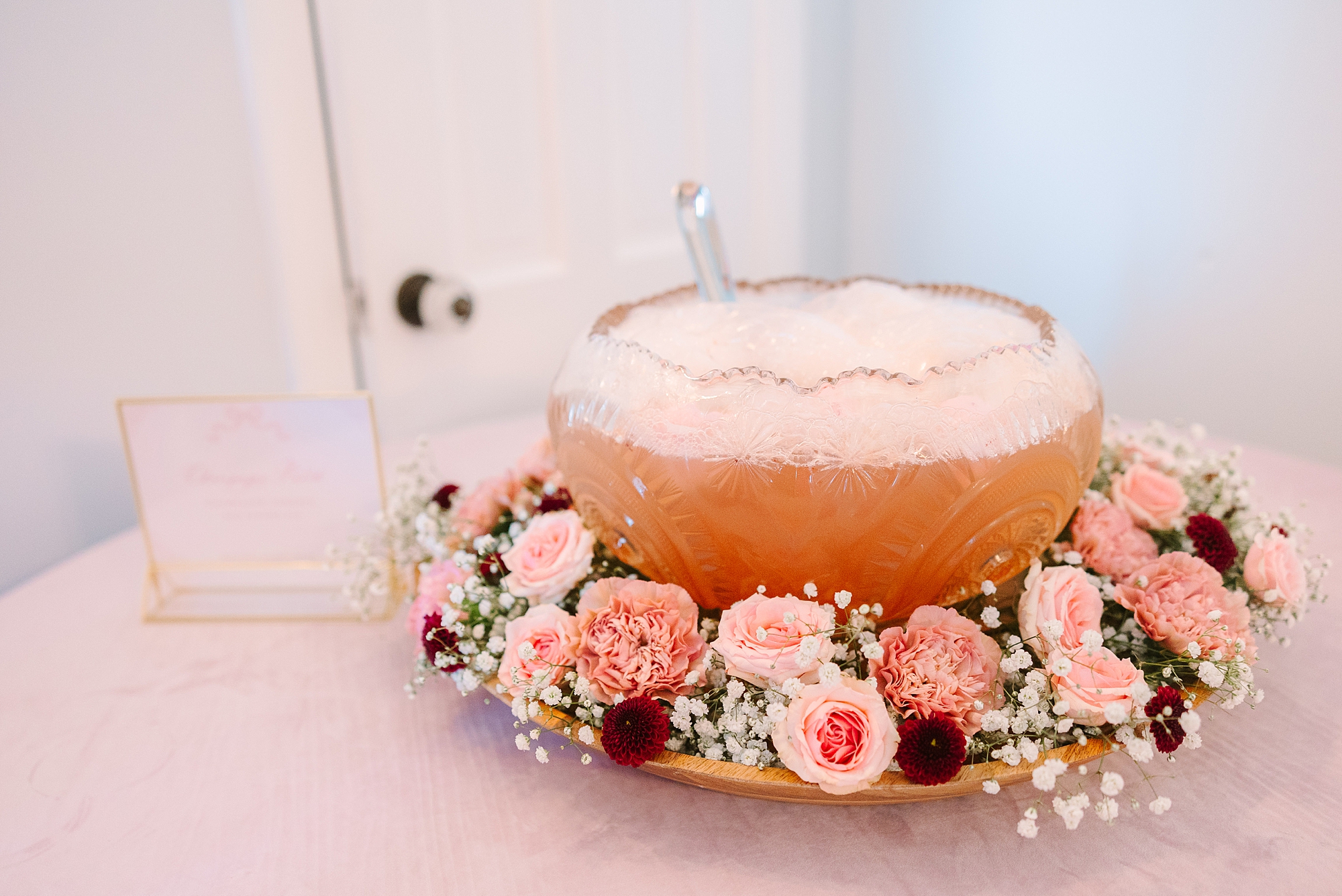 punch bowl with pink flowers and baby's breath on table at Galentine's Day at Magnolia Acres