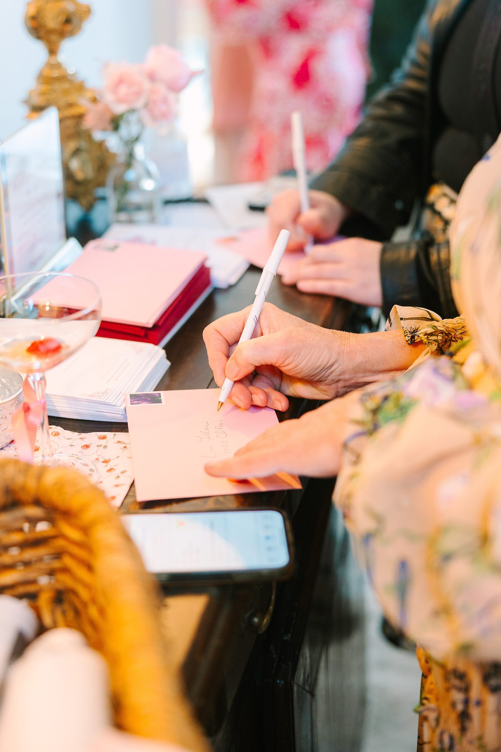 women write notes during Galentine's Day tea at Magnolia Acres