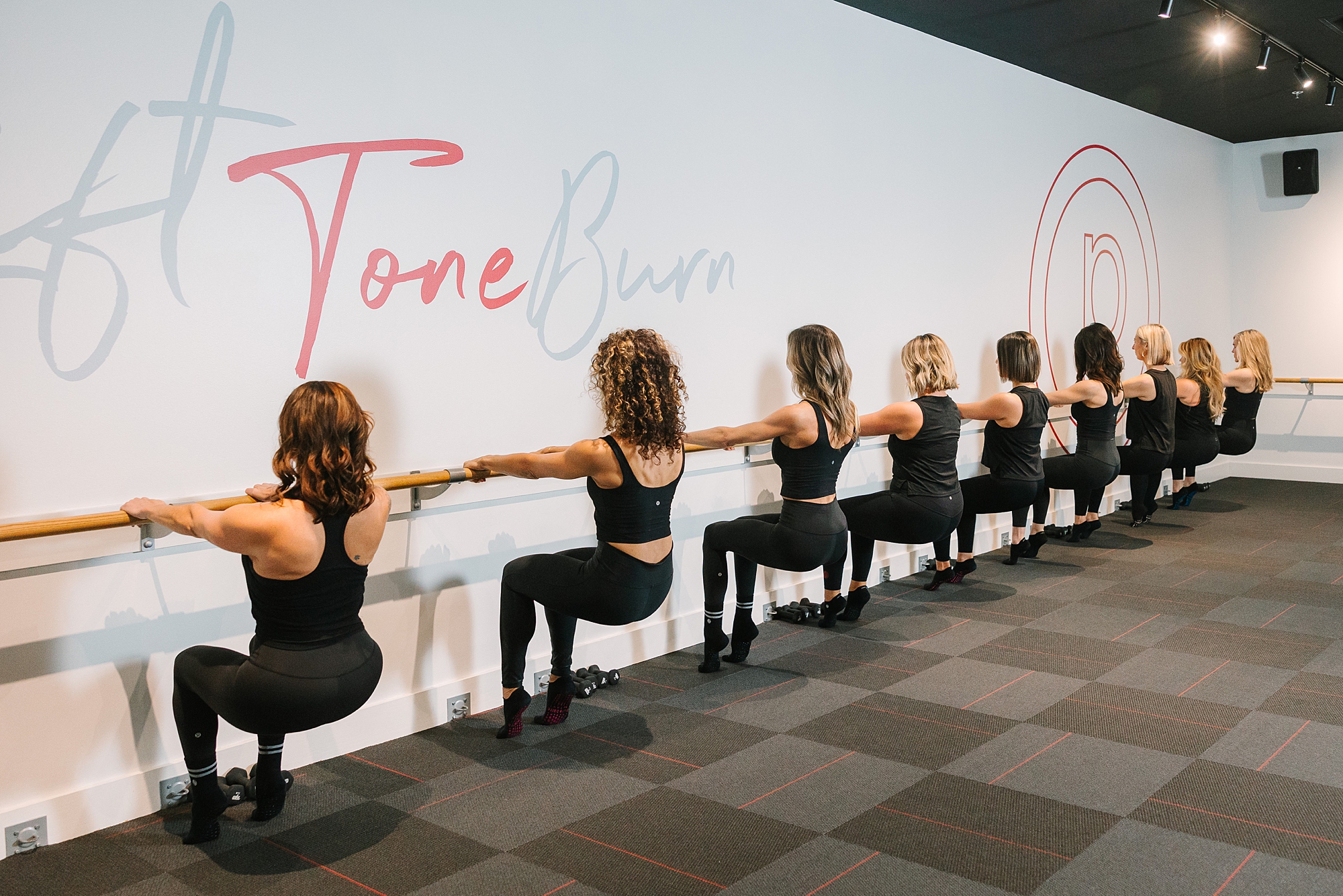 women plie at barre during class with Pure Barre Westhaven