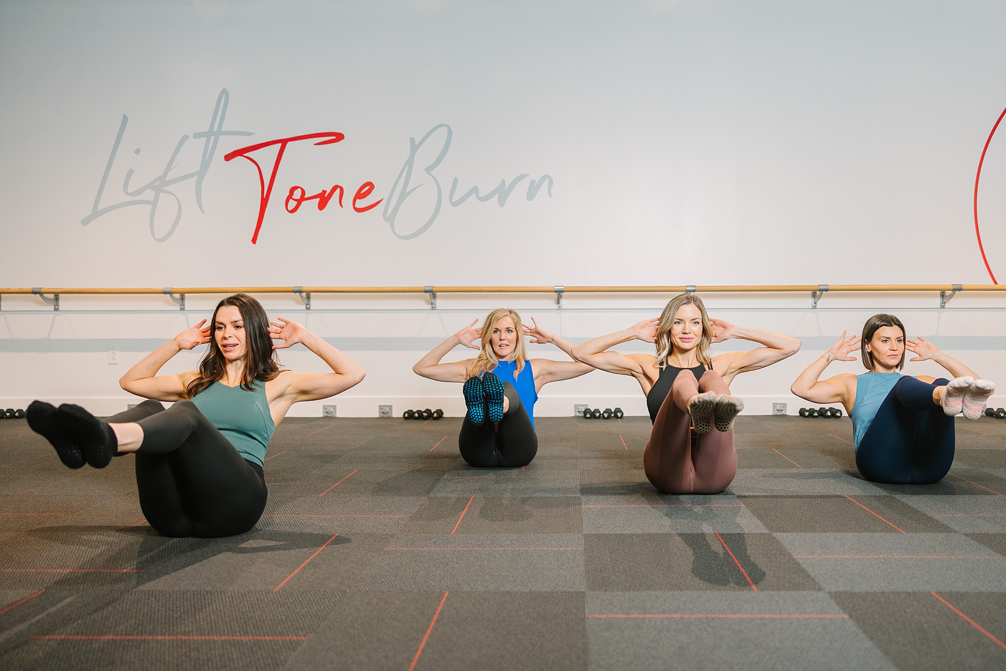 women do crunches during branding photos for Pure Barre Westhaven