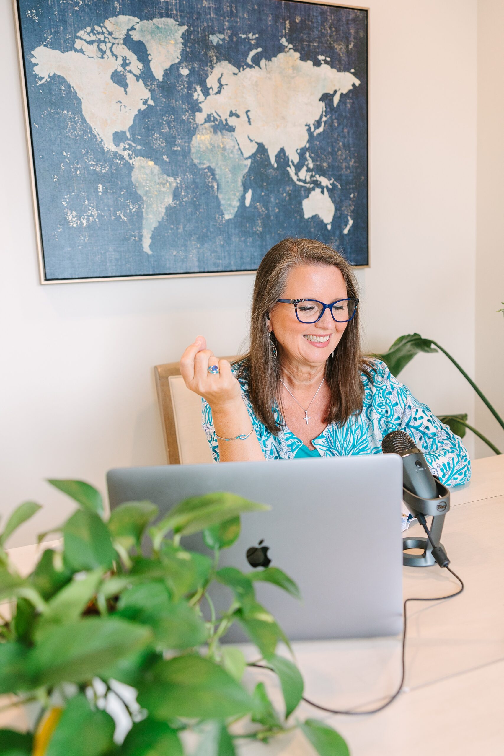 woman talks into microphone sitting at desk in the Sapphire Suite