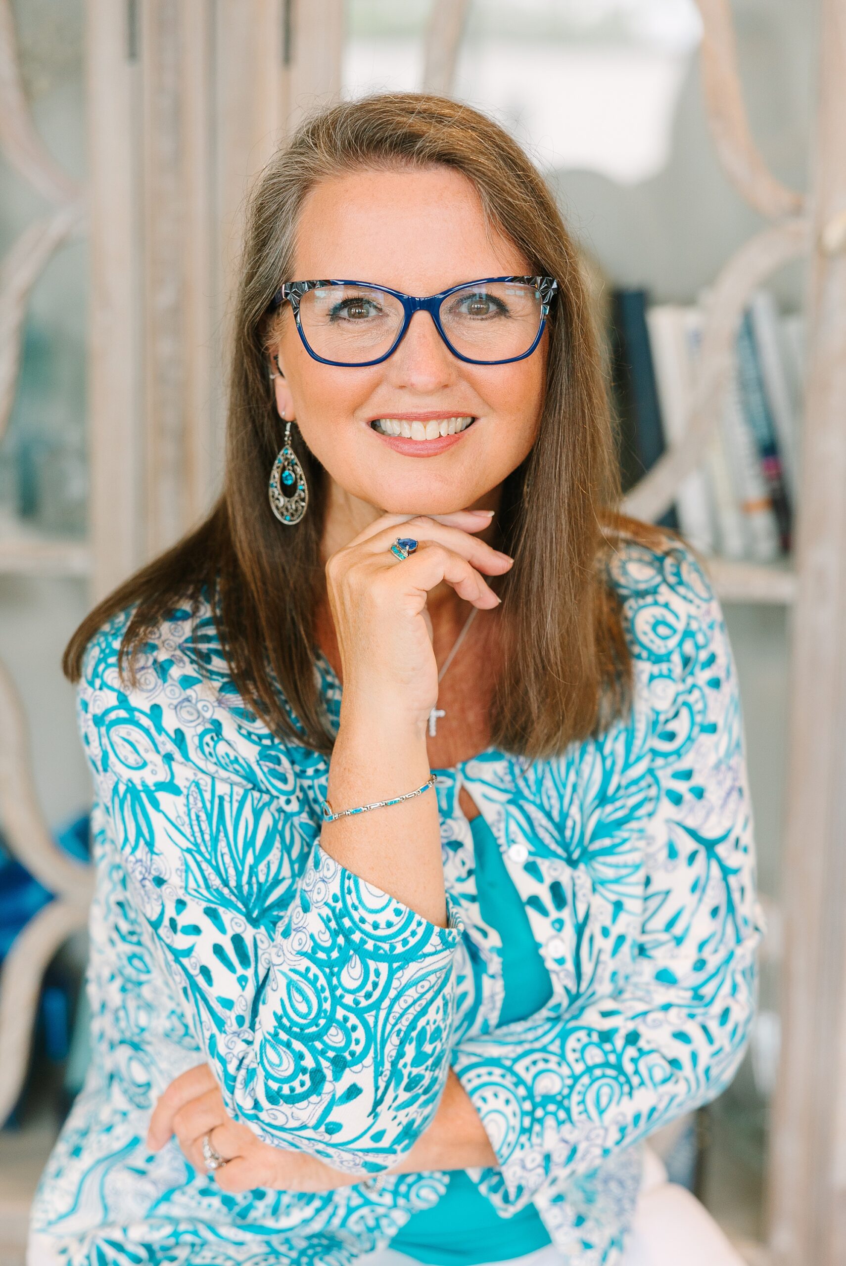 woman leans on hand under her chin during branding photos at the Sapphire Suite